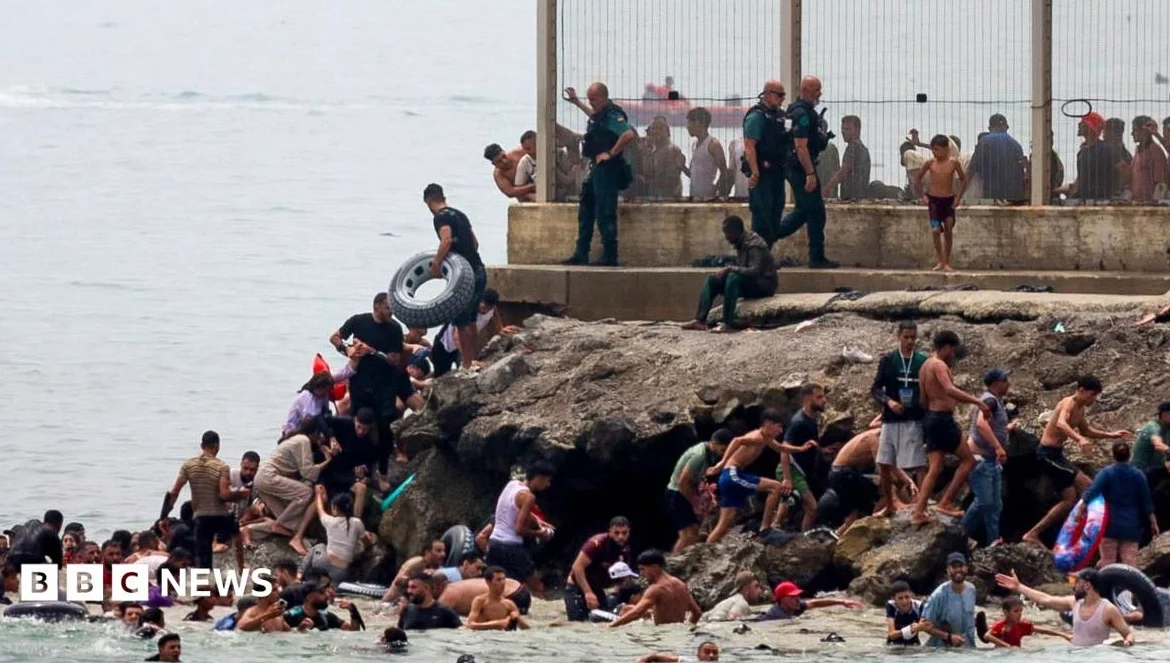 Hundreds of migrants swim from Morocco to Spanish enclave of Ceuta