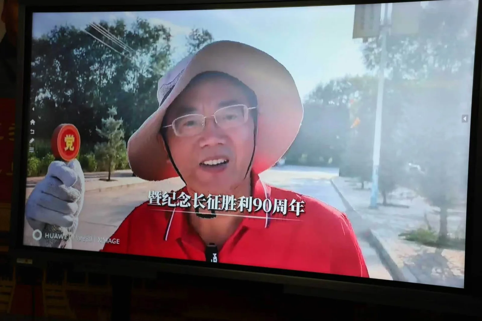 Zhang Heqiang speaks by video link from the Long March route